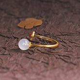 Hetian Jade Clouds Ring – side view white jade bead on gold band with dark textured background and gold leaf, jade ring