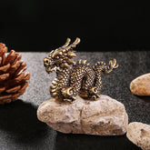Auspicious Brass Dragon Decoration - Crouching dragon on rough stone with pine cone, artisanal collectible