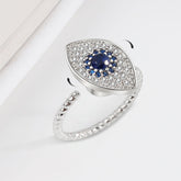 Evil Eye Rotatable Ring – Silver spinner ring with blue sapphire center, pave halo, twisted rope band