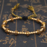 Tibetan Gold Om Mani Padme Hum Bracelet – Gold mantra beads on dark script backdrop, Tibetan jewelry