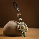 Tibetan Bodhi Seed Peace Key Chain – Gold Ganesha medallion with turquoise coral inlay on cord, spiritual charm