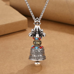 Tibetan Vajra Bell Pendant – Front view of engraved bell with gold band and stone accents, spiritual necklace