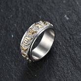 Om Mani Padme Hum Ring – Silver spinner band with gold Tibetan mantra on dark slate, titanium steel