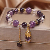 Natural Amethyst PiXiu Healing Bracelet – purple and clear crystal beads with gold PiXiu pendant on jewelry box, copper healing unisex accessory