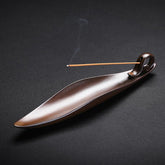 Ceramic Incense Burner – Brown leaf-shaped holder with burning stick and rising smoke, Zen