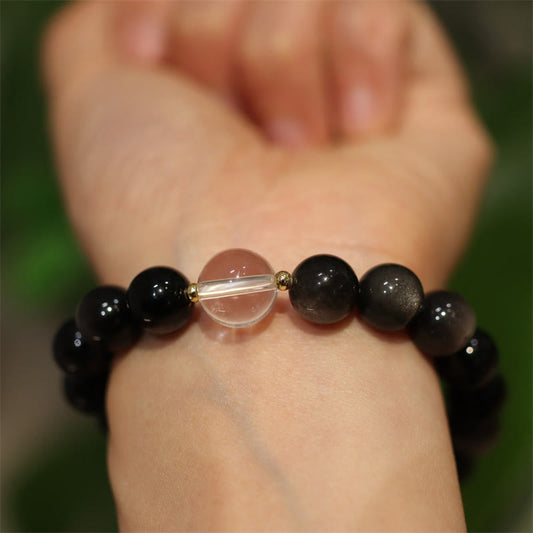 Yin Yang Obsidian Crystal Bracelet - Black beads with clear quartz center on wrist, obsidian bracelet