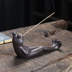Meditation Frog Ceramic Incense Burner - Frog lounging with webbed feet on aged wood plank, ceramic frog decor