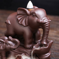Elephant Purple Clay Incense Burner – Close-up smoke waterfall through elephant trunk into lotus basin, dark bg