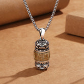 Om Mani Padme Hum Necklace Pendant – Two-tone silver and gold prayer wheel on kraft paper, spiritual jewelry