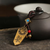 Feng Shui Bagua & Yin Yang Copper Keychain - Antique brass talisman with turquoise inlay on dark surface, feng shui amulet