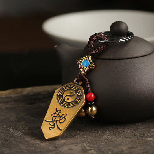 Feng Shui Bagua & Yin Yang Copper Keychain - Antique brass talisman with turquoise inlay on dark surface, feng shui amulet