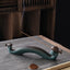 Double Koi Fish Mountain Incense Burner - teal wave holder with bronze koi and rising smoke on gray mat, koi incense burner