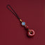 Natural cinnabar zodiac amulet with blue enamel zodiac charm detailed close-up