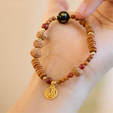 Bodhi Seed Bracelet – Worn on wrist displaying black onyx bead and gold Fu charm, prayer beads