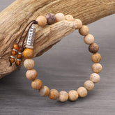 Weathered Stone Om Mani Padme Hum Bracelet – natural stone beads with mantra charm on driftwood, boho spiritual jewelry