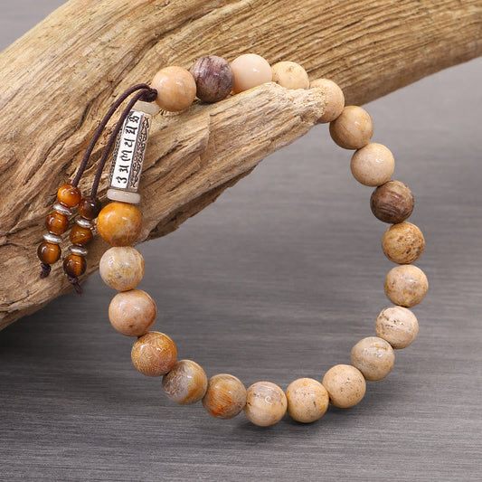 Weathered Stone Om Mani Padme Hum Bracelet – natural stone beads with mantra charm on driftwood, boho spiritual jewelry