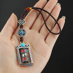 Om Mani Padme Hum Prayer Wheel Keychain – Held in palm showing scale, black background, Tibetan blessing keychain