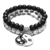 Black Onyx White Turquoise Yin Yang Couple Bracelet Set – Stacked pair of matte black onyx and white turquoise beaded bracelets with silver lotus spacer and split yin-yang charm on white background