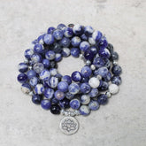 Blue Aventurine Lotus Peace Bracelet – coiled multi-strand beads with silver lotus charm on gray stone, natural gemstone wrap bracelet