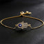 Gold Hamsa Hand Evil Eye Bracelet with Pavé Crystals on Black Background, Protection Jewelry