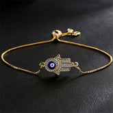 Gold Hamsa Hand Evil Eye Bracelet with Pavé Crystals on Black Background, Protection Jewelry
