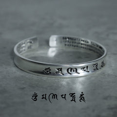 Tibetan Mantra Copper Bracelet - Low angle showing six-syllable mantra on outer band, copper bangle