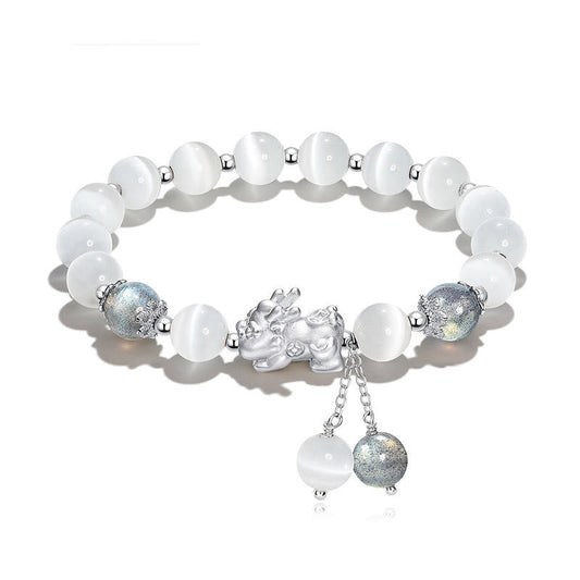Cat's Eye PiXiu Bracelet – Flat lay on white with cat's eye beads and ornate silver PiXiu centerpiece
