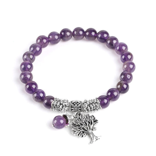 Tree of Life amethyst bracelet with purple gemstone beads, antique silver Tree of Life pendant with branches and roots, silver floral spacers on white background.