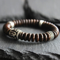 Om Mani Padme Hum Coconut Shell Bracelet – diagonal shot with silver spacer, coconut bead bracelet