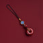 Natural cinnabar zodiac amulet with blue enamel zodiac charm isolated product view
