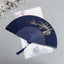 Plum Blossom Fan White – Navy fan with gold plum blossoms on white background, bamboo folding fan