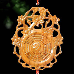 Peach Wood Bagua Map - Close-up on dark background, bagua yin yang wood ornament