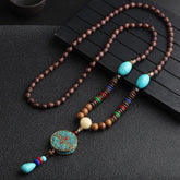 Turquoise Dzi Bead Prayer Wheel Wenge Wood Necklace - Long ethnic necklace with dark wood beads, turquoise oval stones, mosaic turquoise pendant, and colorful tassel