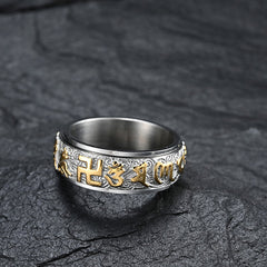 Om Mani Padme Hum Ring – Dark stone background highlighting gold Buddhist mantra on silver spinner band