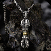 Tibetan Vajra Dorje Pendant Necklace – Oxidized silver with gold lotus accents and ornate filigree, dark volcanic rock backdrop