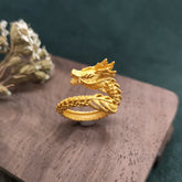 Golden Dragon Success Strength Ring - coiled dragon ring with scales on wood stand, power symbol