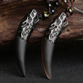 Ice obsidian wolf tooth pendant necklace pair featuring hand-carved wolf head on black obsidian fang with gold-inscribed mantra bead and adjustable braided cord in black and burgundy