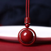 Cinnabar PiXiu Necklace – Front close-up red bead in circle pendant with mantra carving, cinnabar blessing jewelry