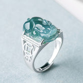 925 Sterling Silver Jade PiXiu Luck Ring – Blue-green jade PiXiu on silver band with diamonds, light blue fabric