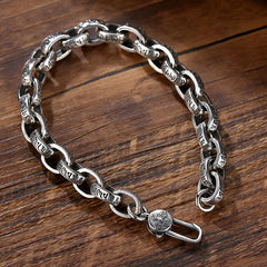 Silver Om Mani Padme Hum Bangle – Three-quarter view on wood, toggle clasp detail