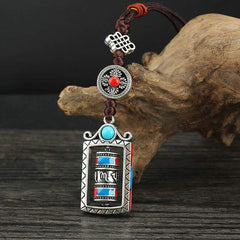 Om Mani Padme Hum Prayer Wheel Keychain – Frontal view showing endless knot and red stone medallion, Tibetan pendant