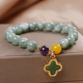 Green jade beaded bracelet with amethyst and yellow jade accent stones, gold four-leaf clover charm, natural gemstone jewelry for women
