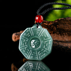 Natural Jade Bagua Yin Yang Pendant - Octagonal jade pendant with yin-yang and trigrams on black backdrop