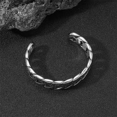 Tibetan Om Mani Padme Hum Cuff Bangle – dramatic lighting on black sand, twisted chain link detail, open cuff design