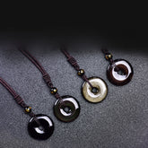 Tibetan obsidian protection necklace set showing four ping'an kou pendant varieties in glossy black smoky gray golden sheen and mahogany obsidian with gold-inscribed mantra beads on braided cords