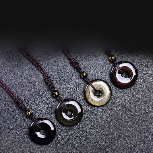 Tibetan obsidian protection necklace set showing four ping'an kou pendant varieties in glossy black smoky gray golden sheen and mahogany obsidian with gold-inscribed mantra beads on braided cords