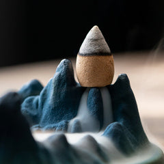 Ceramic Backflow Incense Burner – Close-up of blue mountain peaks with dense smoke cascading into basin, aromatherapy