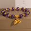 Natural Amethyst Lotus Healing Bracelet - purple beads with gold lotus charms on neutral display, spiritual