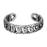 Tibetan Om Mani Padme Hum Cuff Bangle – front view on white, twisted silver links with Tibetan engraving, titanium steel