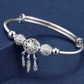 Dream Catcher Blessing Bracelet – Silver bangle with filigree dreamcatcher and feather dangles on navy, boho silver